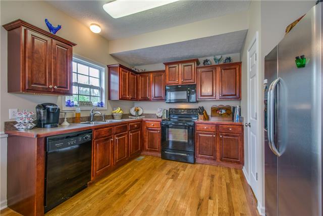 515 Berry Circle Springfield, TN 37172 - Photo 6 of 18 a kitchen with stainless steel appliances granite countertop a refrigerator stove and sink