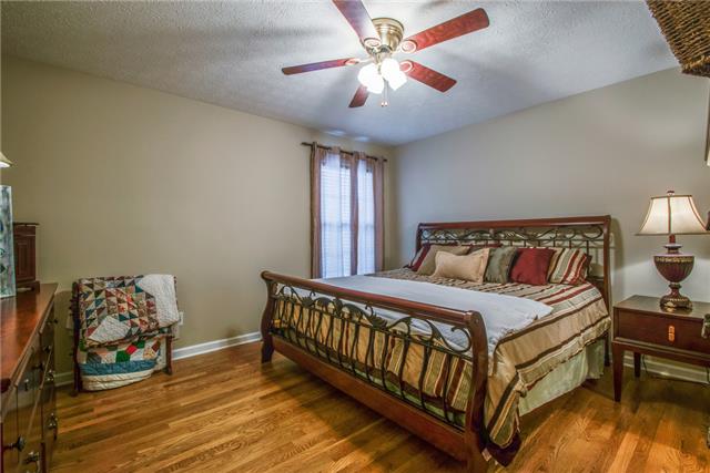 515 Berry Circle Springfield, TN 37172 - Photo 8 of 18 a bedroom with a bed and a chandelier