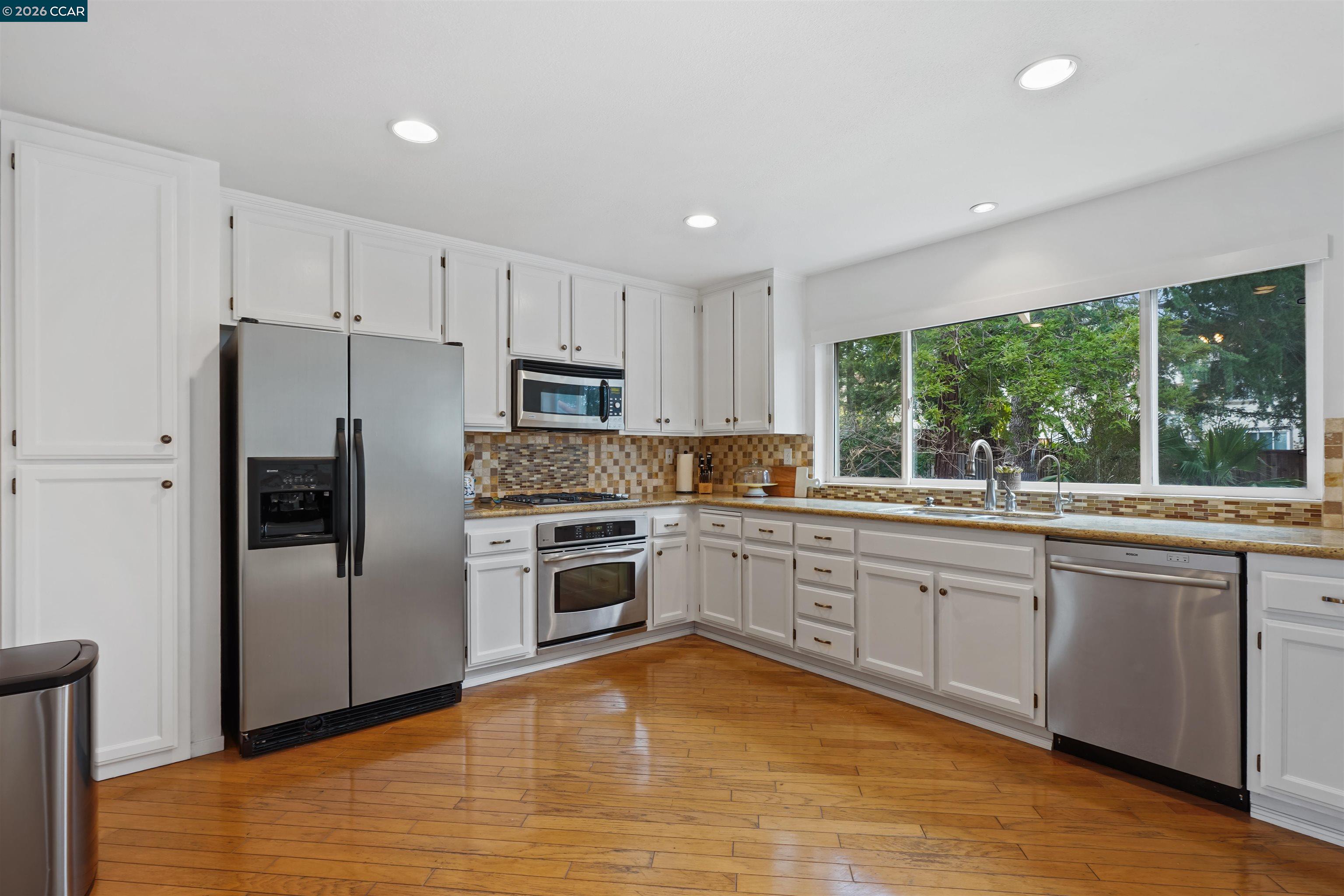 2175 Bluerock Circle Concord, CA 94521 - Photo 11 of 48 a kitchen with granite countertop white cabinets and stainless steel appliances