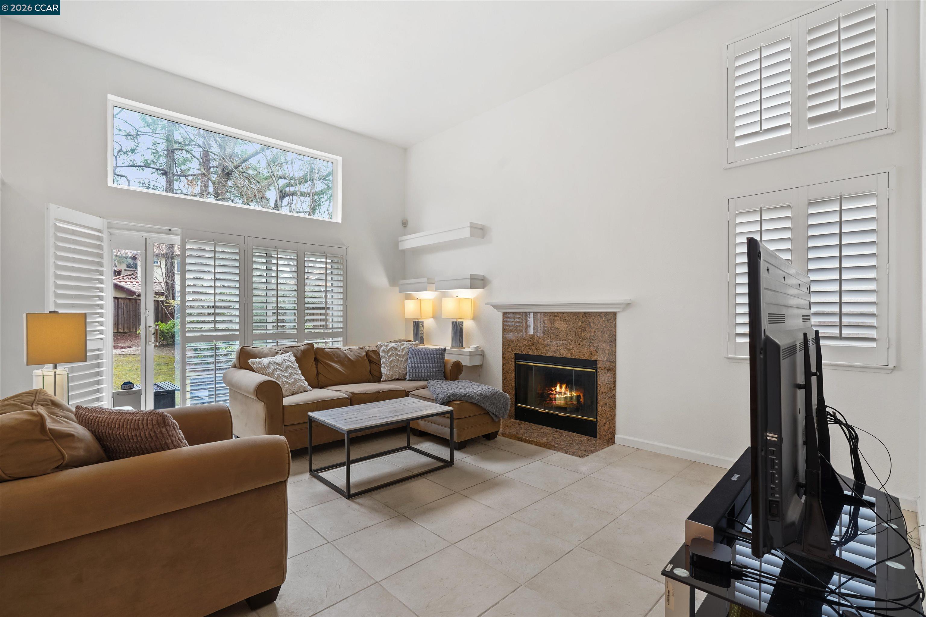 2175 Bluerock Circle Concord, CA 94521 - Photo 15 of 48 a living room with furniture a large window and a fireplace