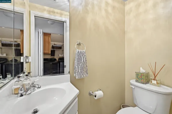 a bathroom with a sink a toilet and shower curtain
