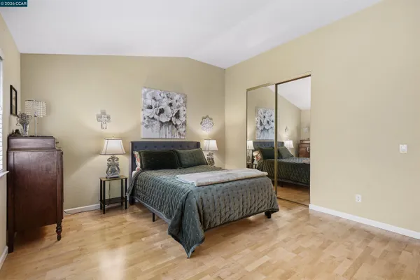 a bedroom with a bed and a painting on the wall