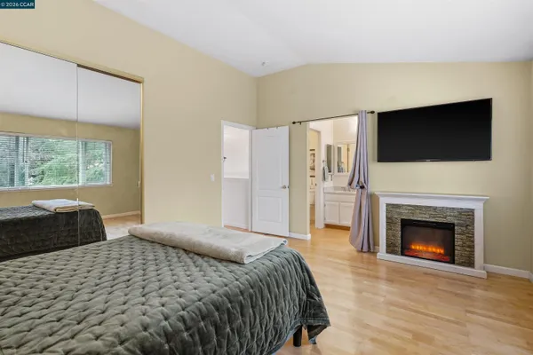 a bedroom with a bed and a fireplace