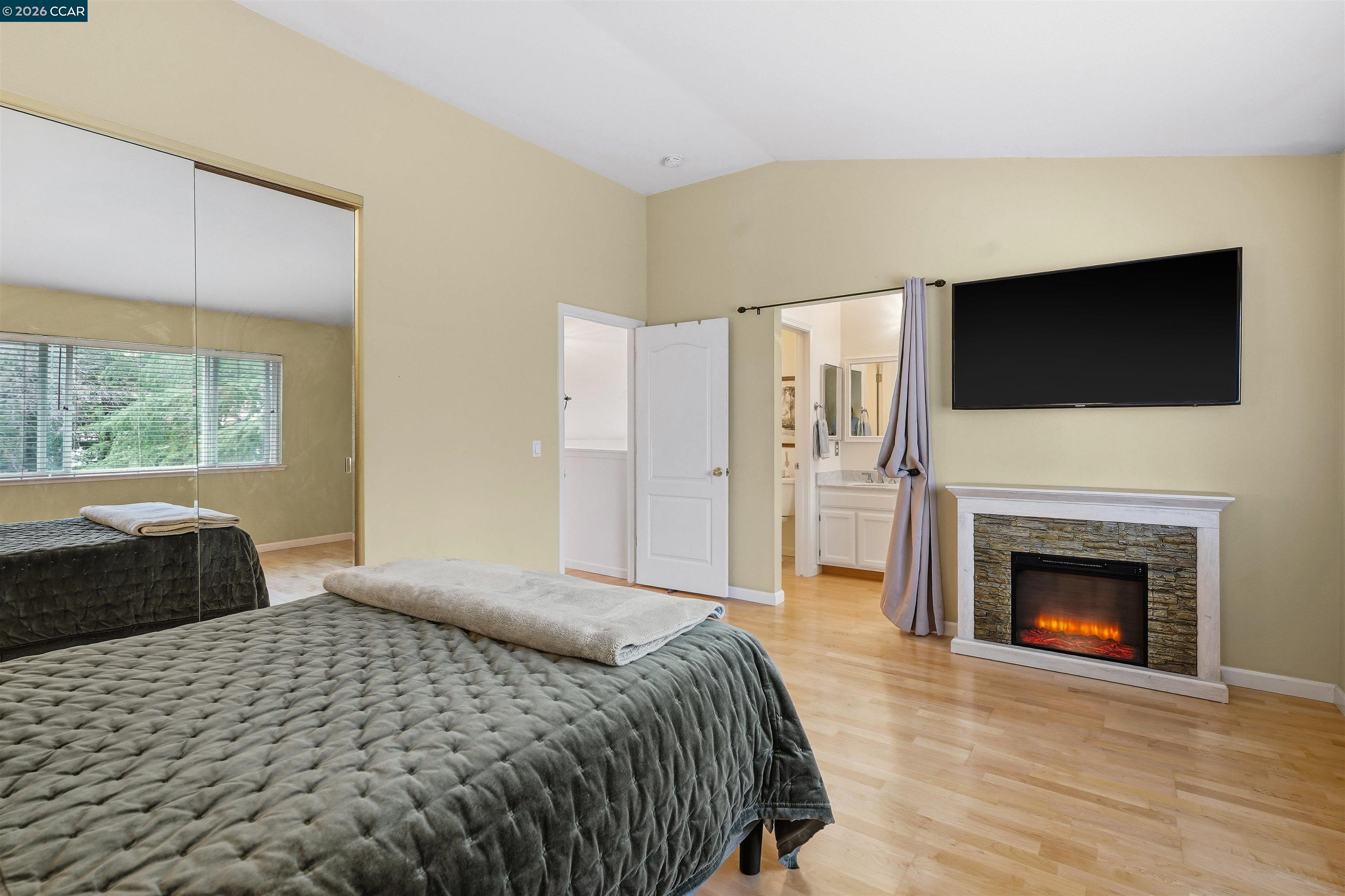 2175 Bluerock Circle Concord, CA 94521 - Photo 25 of 48 a bedroom with a bed and a fireplace
