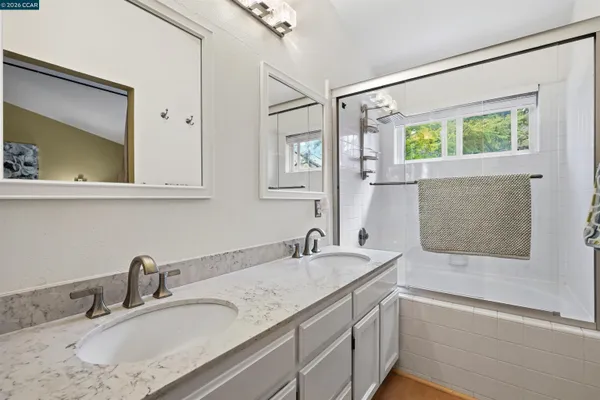 a bathroom with a granite countertop sink mirror and double