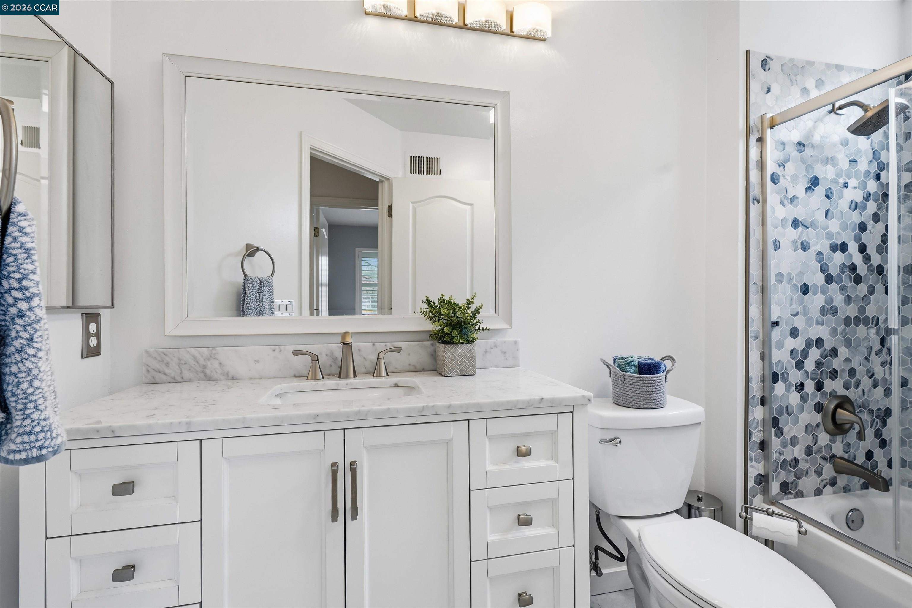 2175 Bluerock Circle Concord, CA 94521 - Photo 31 of 48 a bathroom with a granite countertop sink a toilet and a mirror