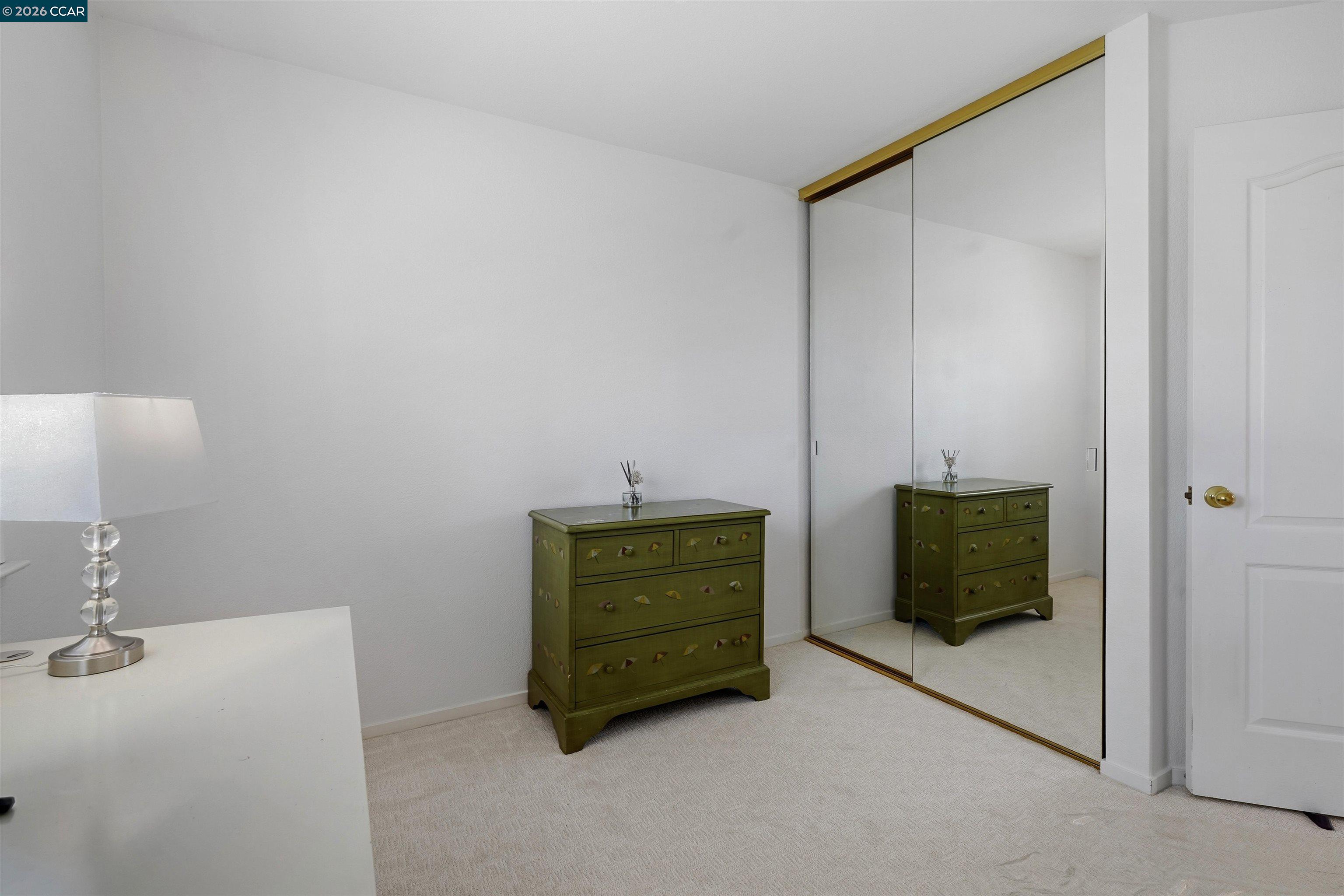 2175 Bluerock Circle Concord, CA 94521 - Photo 35 of 48 a room with a bed and a mirror