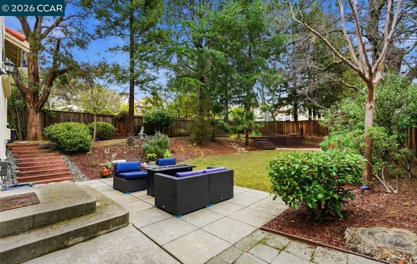 a view of a patio with couches table and chairs and potted plants