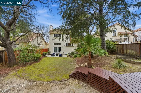 a view of a house with backyard and sitting area