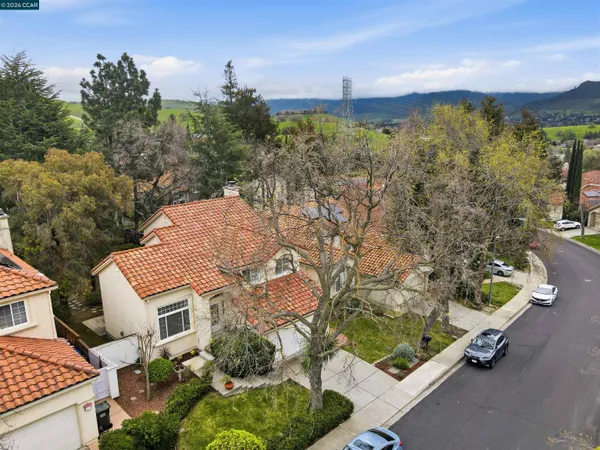 an aerial view of a house with a yard basket ball court and outdoor seating