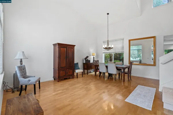a dining room with furniture window and wooden floor