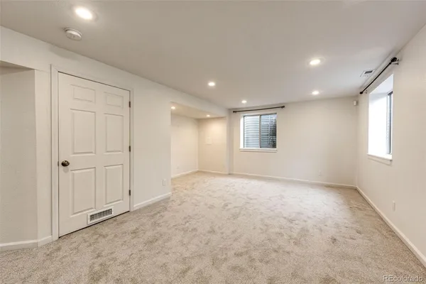 an empty room with windows and closet