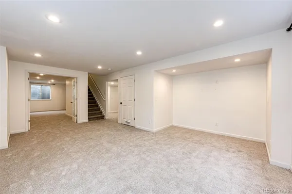 an empty room with a cabinet and mirrors