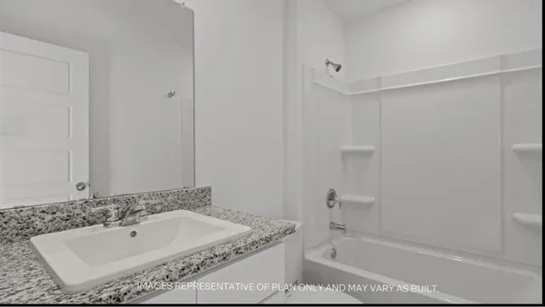 a bathroom with a bathtub and shower