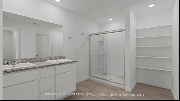 a bathroom with a shower sink vanity and mirror