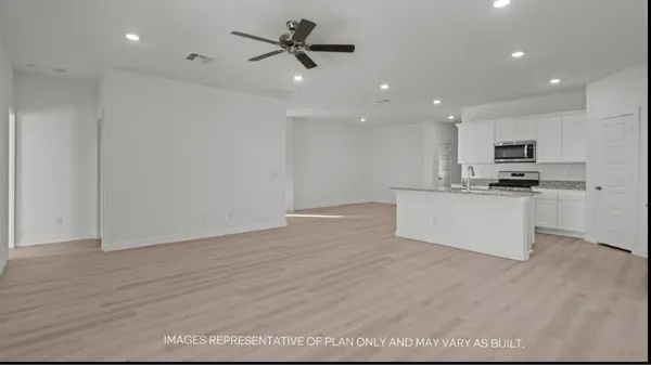 a view of kitchen with microwave and cabinets