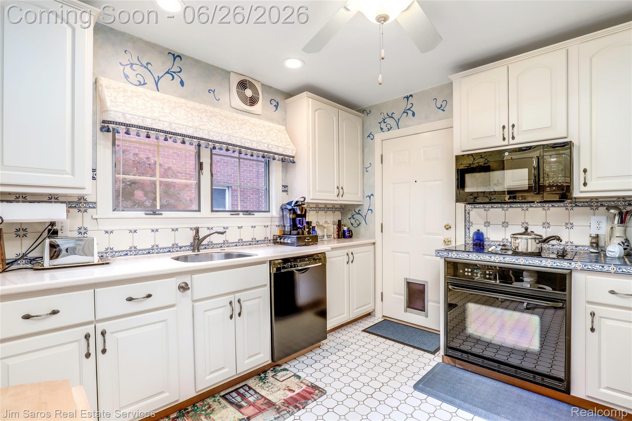 764 Harcourt Road Grosse Pointe, MI 48230 - Photo 10 of 42 Full kitchen featuring white cabinetry, a built-in oven with a stovetop, and a coordinating microwave