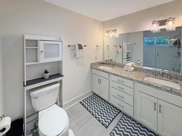 a bedroom with a large bed and a flat screen tv