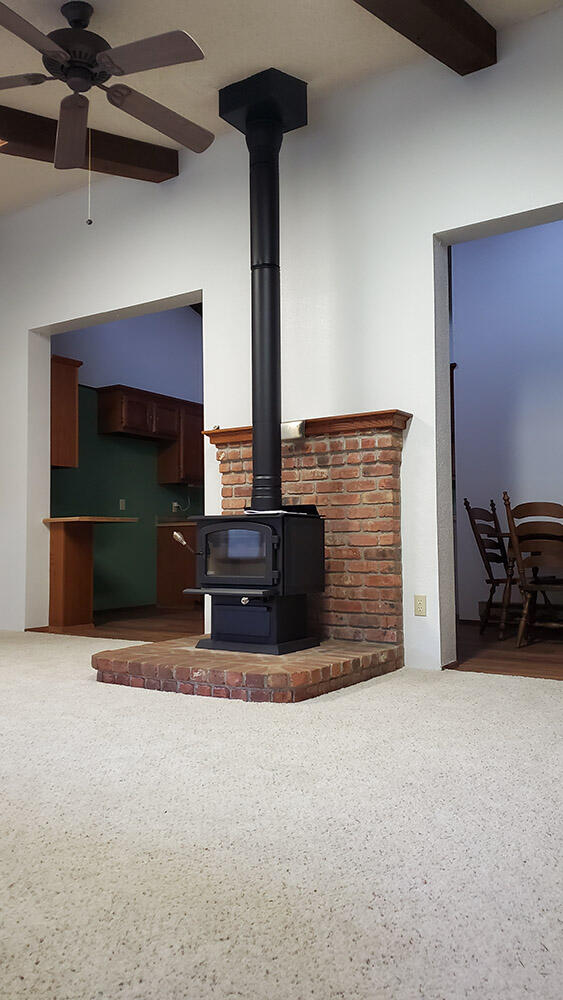 3536 Galice Road Merlin, OR 97532 - Photo 5 of 32 a view of an empty room with a fireplace and a fan