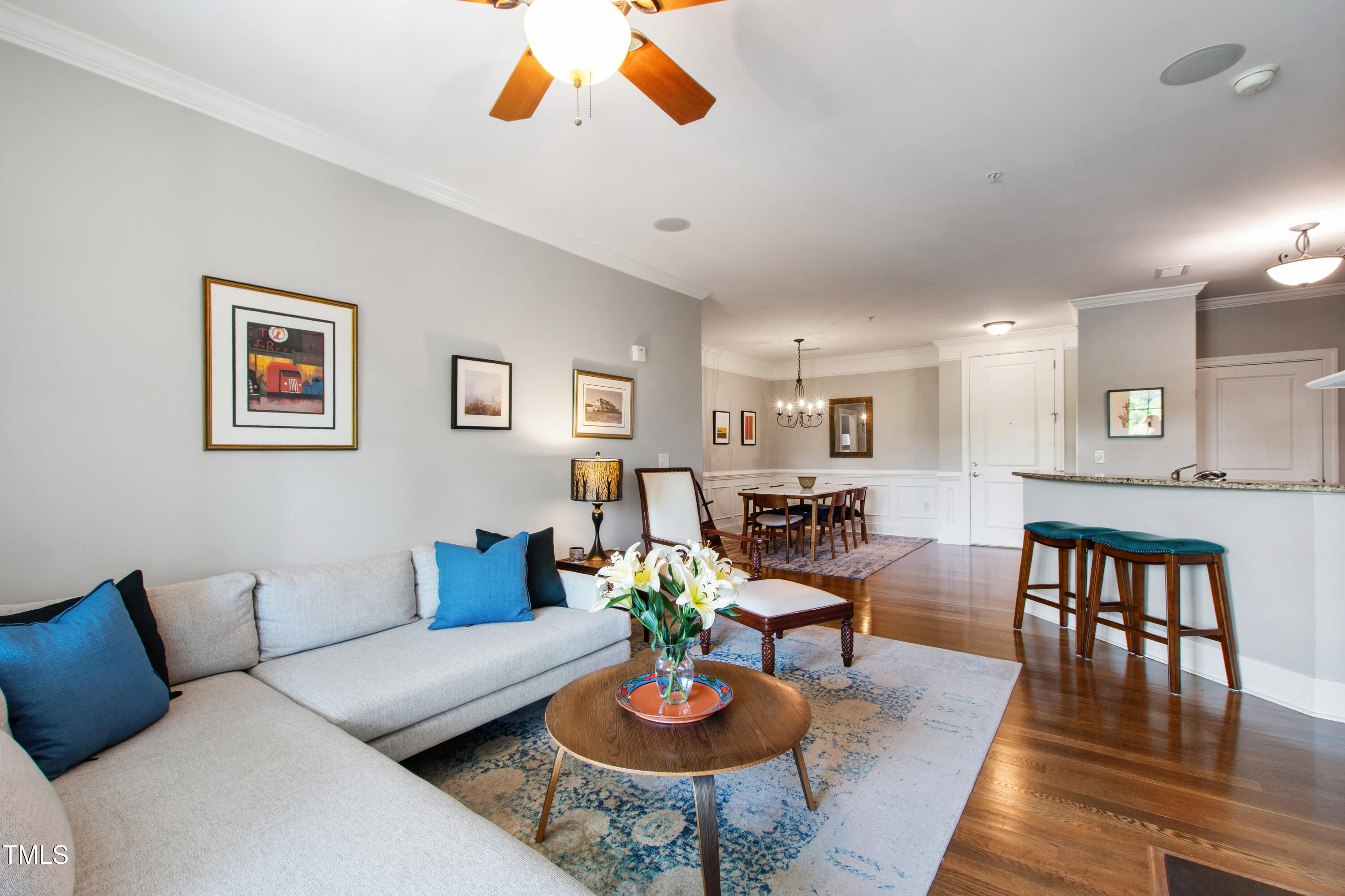 340 Allister Drive, Unit 201 Raleigh, NC 27609 - Photo 14 of 37 a living room with furniture kitchen view and a wooden floor