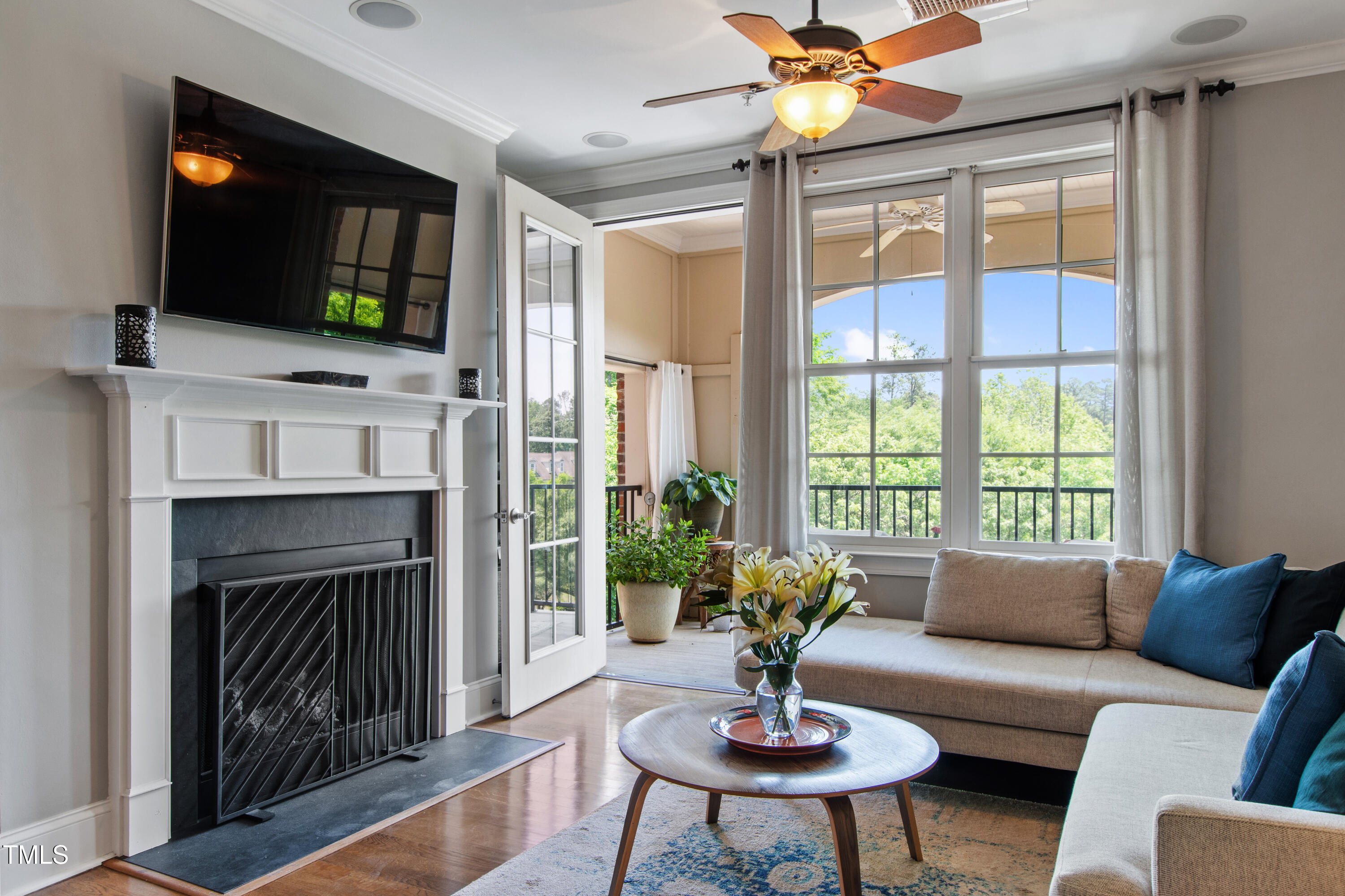 340 Allister Drive, Unit 201 Raleigh, NC 27609 - Photo 15 of 37 a living room with furniture a fireplace and a flat screen tv