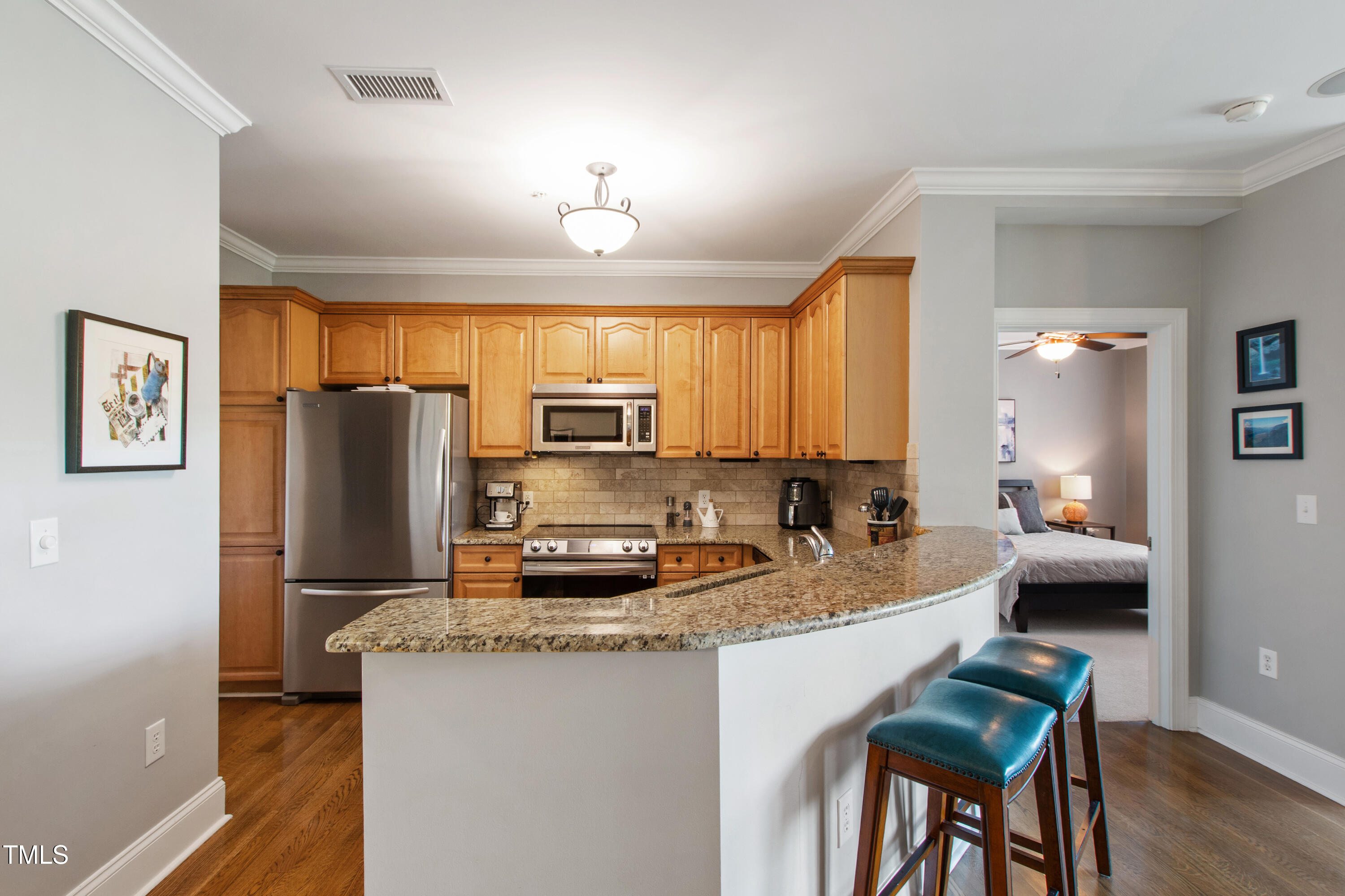 340 Allister Drive, Unit 201 Raleigh, NC 27609 - Photo 17 of 37 a kitchen with refrigerator cabinets and wooden floor