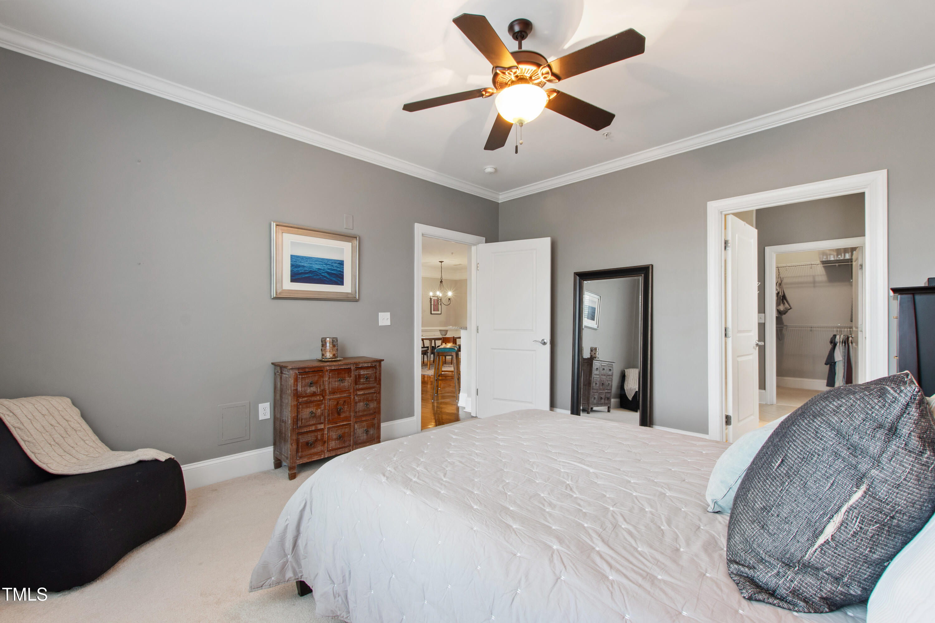 340 Allister Drive, Unit 201 Raleigh, NC 27609 - Photo 19 of 37 a bedroom with a bed and dresser with wooden floor