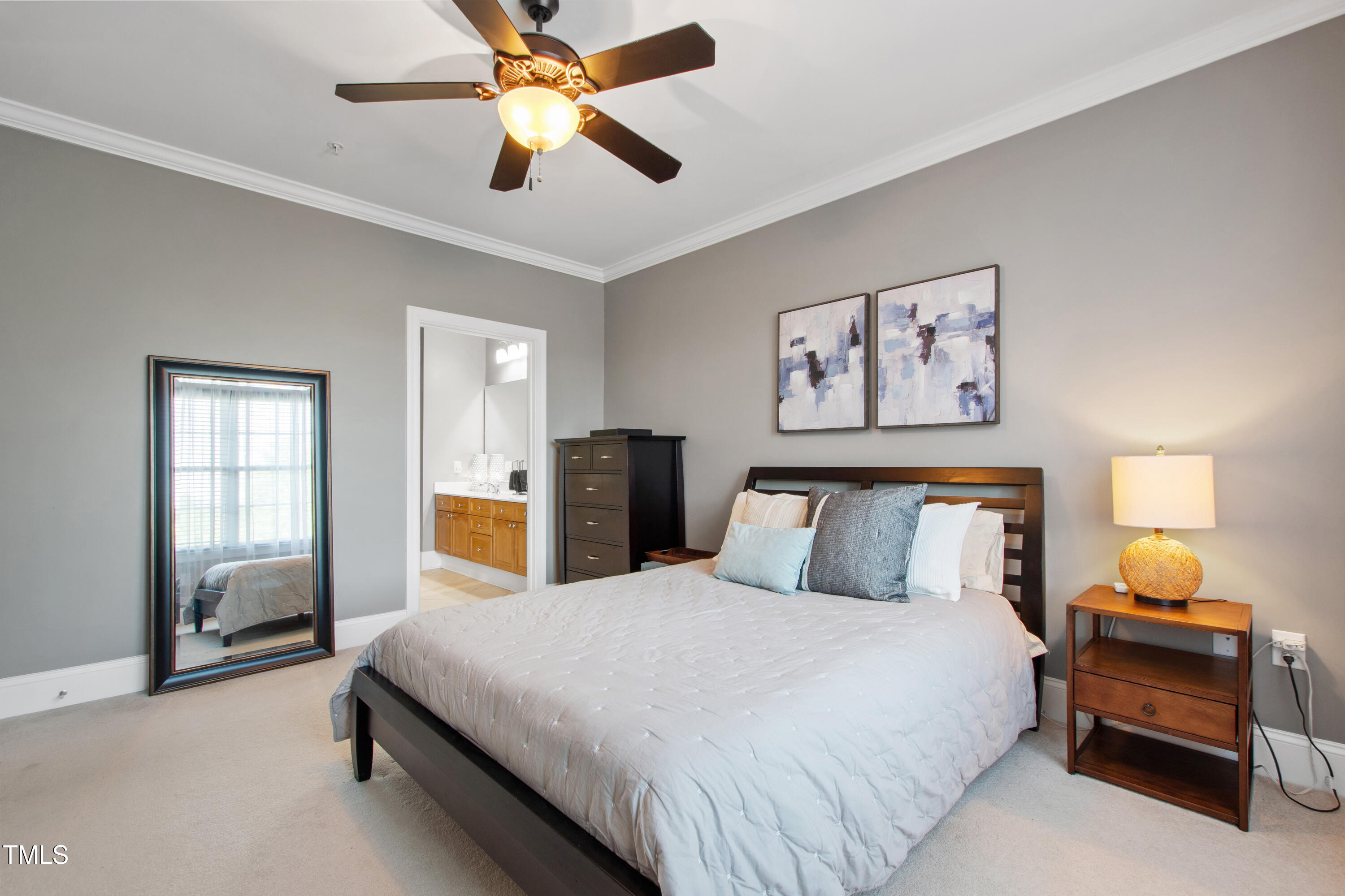 340 Allister Drive, Unit 201 Raleigh, NC 27609 - Photo 20 of 37 a bedroom with a bed and a chandelier
