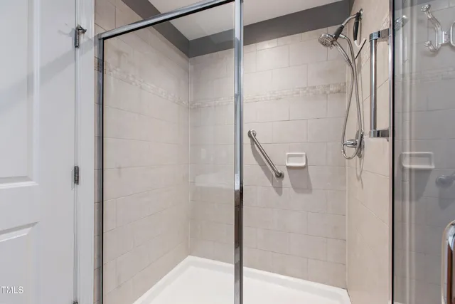 a bathroom with a glass door shower