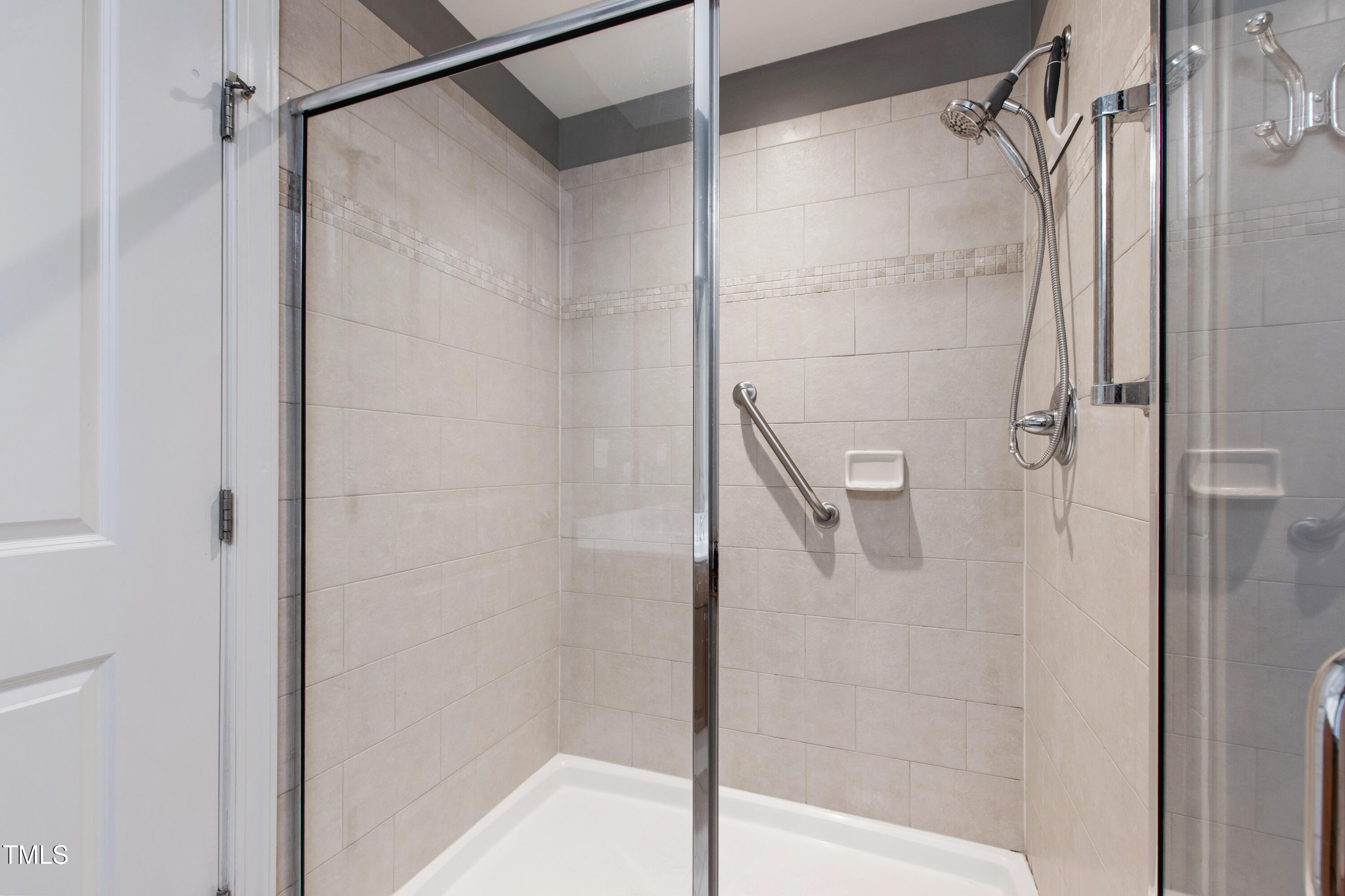 340 Allister Drive, Unit 201 Raleigh, NC 27609 - Photo 22 of 37 a bathroom with a glass door shower