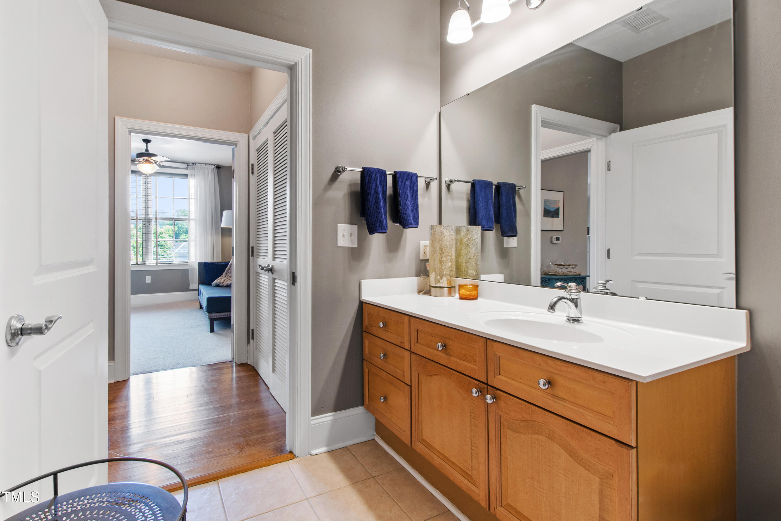 340 Allister Drive, Unit 201 Raleigh, NC 27609 - Photo 28 of 37 a bathroom with a sink a double vanity and a mirror