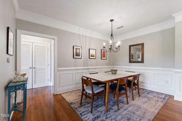 a view of a dining room with furniture wooden floor and a chandelier