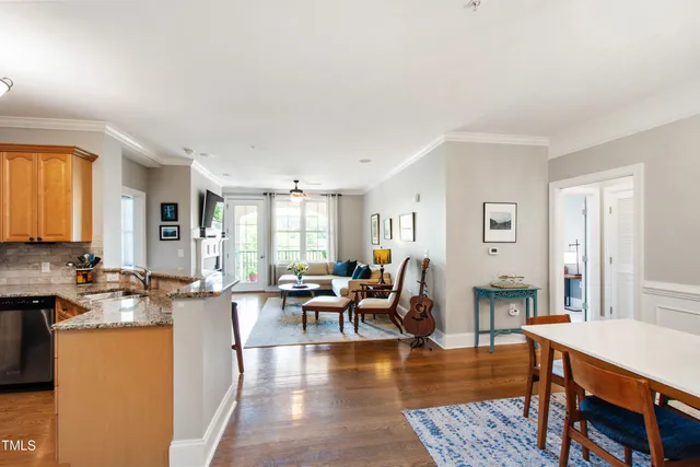 a living room with furniture wooden floor and a table