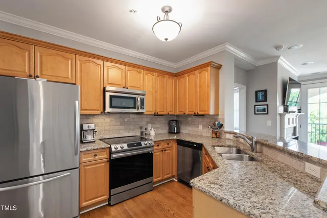 a kitchen with a sink stove and refrigerator