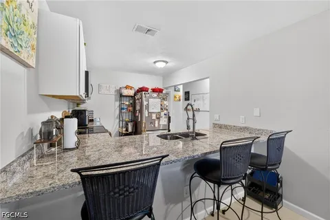 a kitchen with granite countertop kitchen island stainless steel appliances lots of counter top space