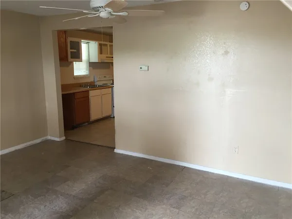 an empty room with a kitchen and a sink