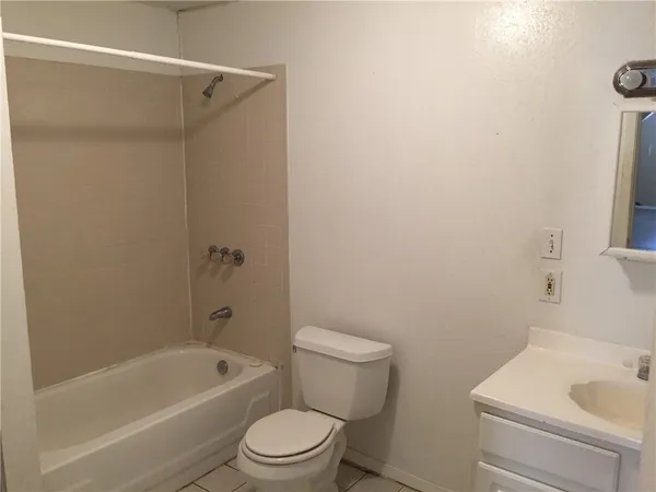 a white toilet sitting next to a bath tub