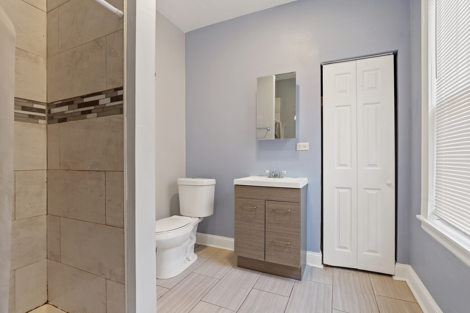 8810 South Racine Avenue Chicago, IL 60620 - Photo 11 of 23 a bathroom with a toilet a sink a vanity and mirror