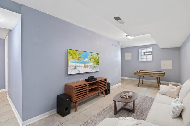 8810 South Racine Avenue Chicago, IL 60620 - Photo 16 of 23 a room with furniture a piano and wooden floor