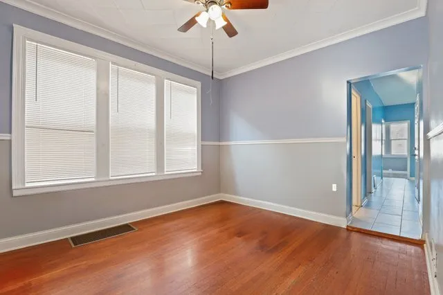 wooden floor in an empty room with a window