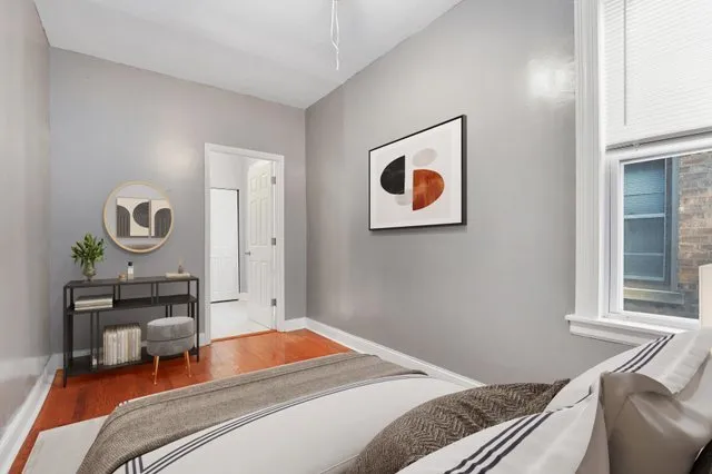 a bedroom with a bed and a window