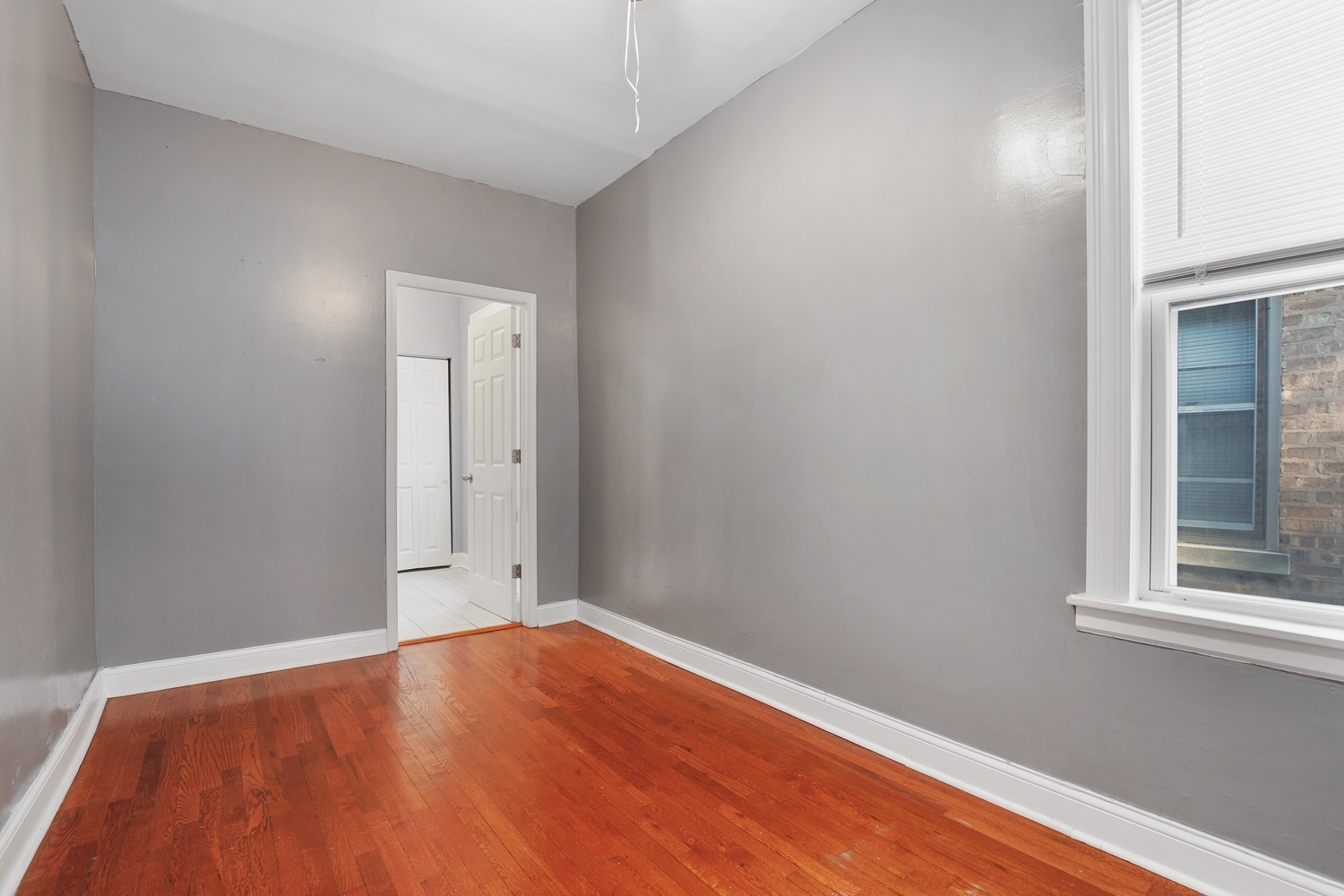 8810 South Racine Avenue Chicago, IL 60620 - Photo 10 of 23 a view of empty room with wooden floor and fan