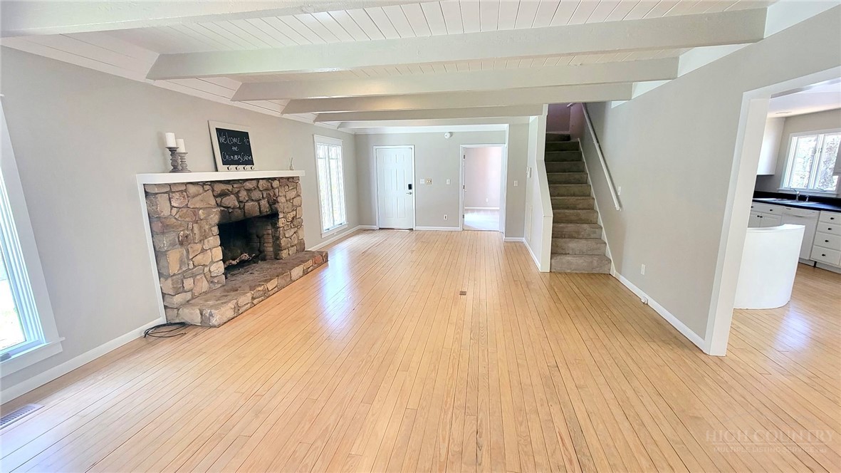 172 Yarrow Lane Boone, NC 28607 - Photo 10 of 30 wooden floor in an empty room with a fireplace