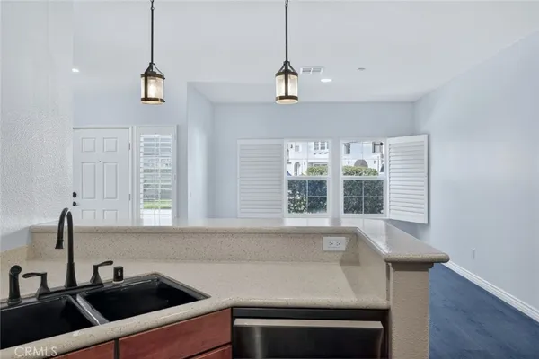 a kitchen that has a sink and a stove in it