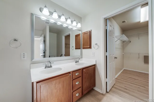 a bathroom with a double vanity sink and a mirror