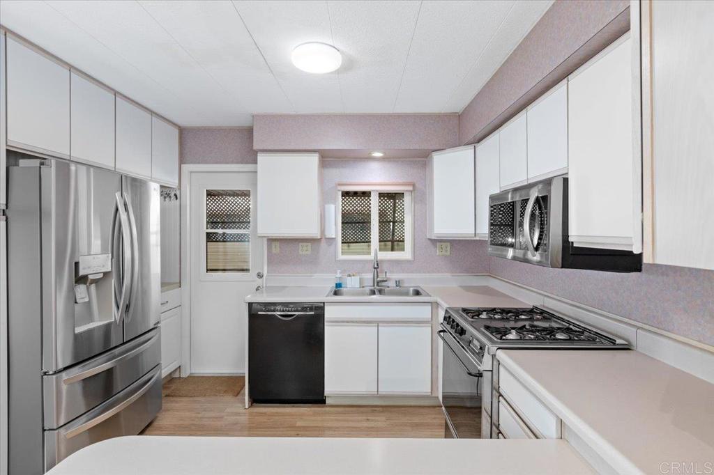 28890 Lilac Road, Unit 80 Valley Center, CA 92082 - Photo 9 of 33 a kitchen with stainless steel appliances granite countertop a stove a refrigerator and a sink