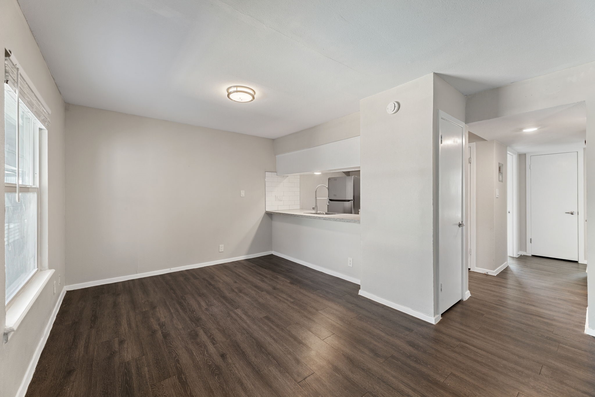 5005 Manor Road, Unit 132 Austin, TX 78723 - Photo 17 of 28 an empty room with wooden floor and windows