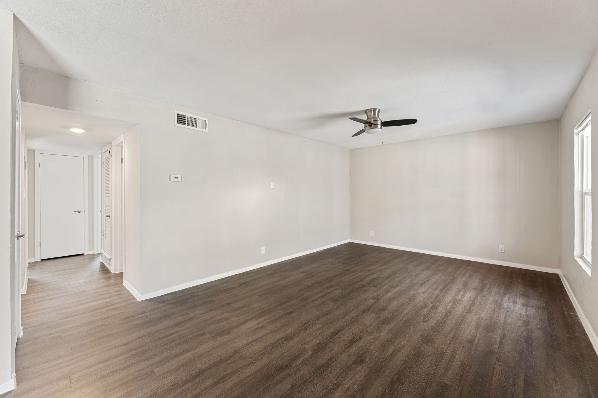 5005 Manor Road, Unit 132 Austin, TX 78723 - Photo 18 of 28 wooden floor in an empty room with a window