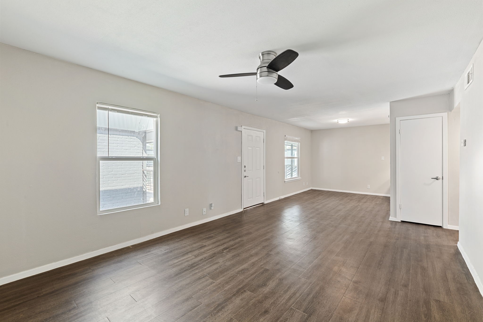 5005 Manor Road, Unit 132 Austin, TX 78723 - Photo 20 of 28 a view of an empty room with a window and wooden floor