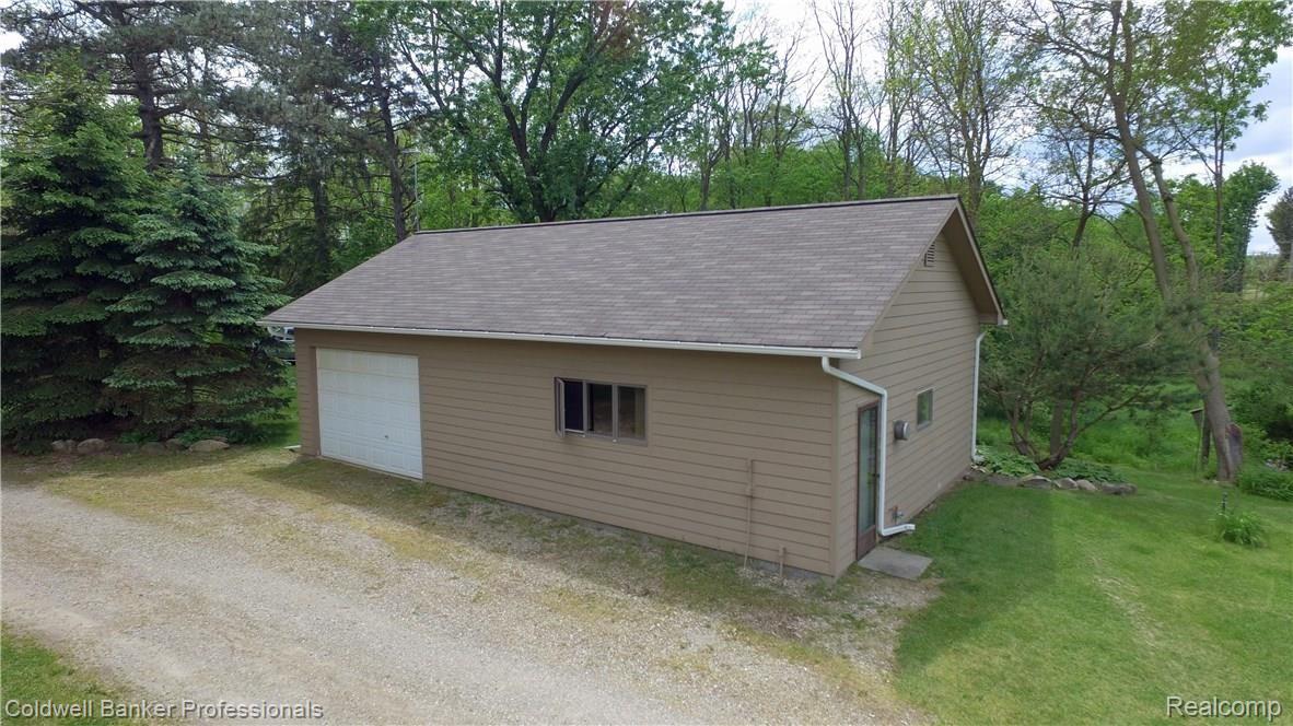305 East Rattalee Lake Road Holly, MI 48442 - Photo 31 of 38 The Workshop with an additional attached bay for an extra vehicle